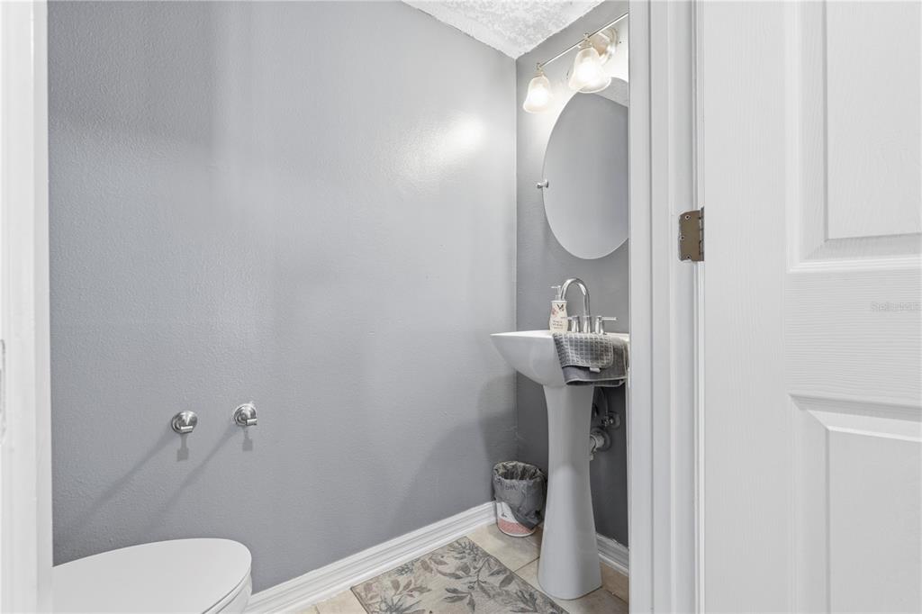 2881 Southwest 142nd Lane Ocala, FL 34473 - Photo 41 of 60 a bathroom with a sink toilet and a mirror