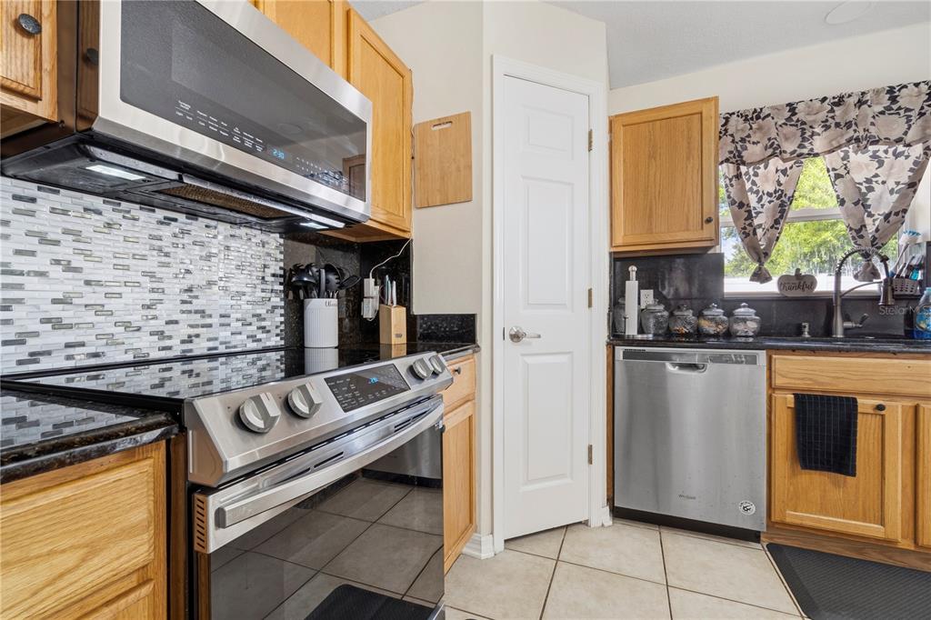 2881 Southwest 142nd Lane Ocala, FL 34473 - Photo 48 of 60 a kitchen with stainless steel appliances granite countertop a stove and a microwave