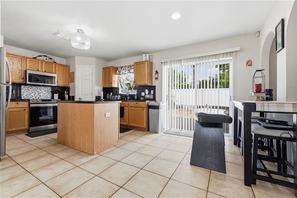2881 Southwest 142nd Lane Ocala, FL 34473 - Photo 50 of 60 a kitchen with cabinets and chairs