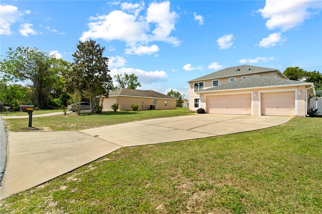 2881 Southwest 142nd Lane Ocala, FL 34473 - Photo 57 of 60 a front view of a house with a yard and garage