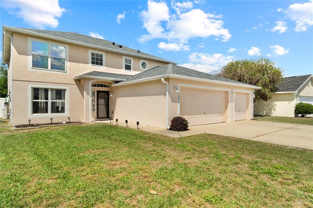 2881 Southwest 142nd Lane Ocala, FL 34473 - Photo 58 of 60 a view of a big house with a big yard and large tree