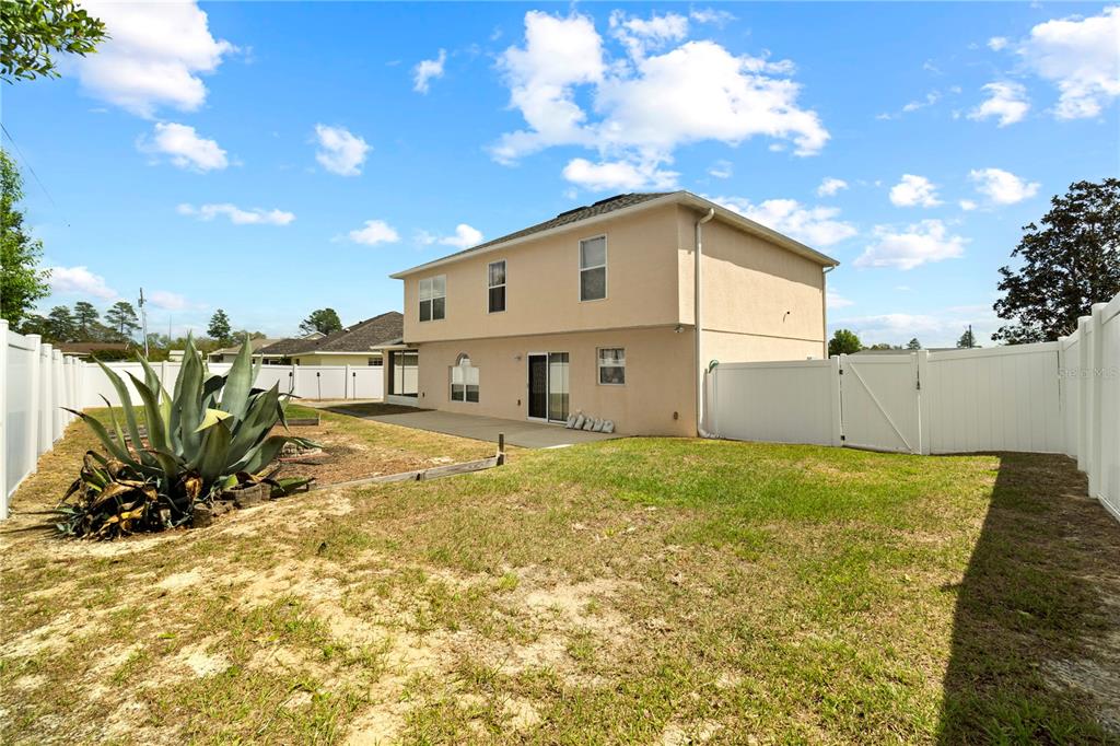 2881 Southwest 142nd Lane Ocala, FL 34473 - Photo 59 of 60 a view of a house with a backyard