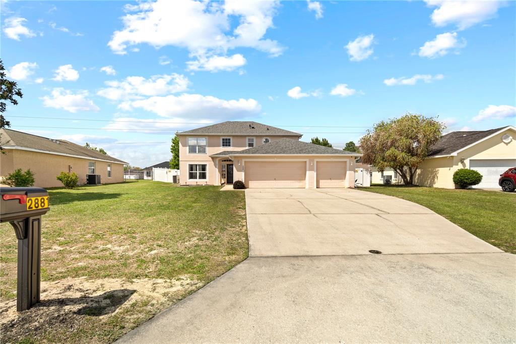 2881 Southwest 142nd Lane Ocala, FL 34473 - Photo 60 of 60 a front view of a house with garden