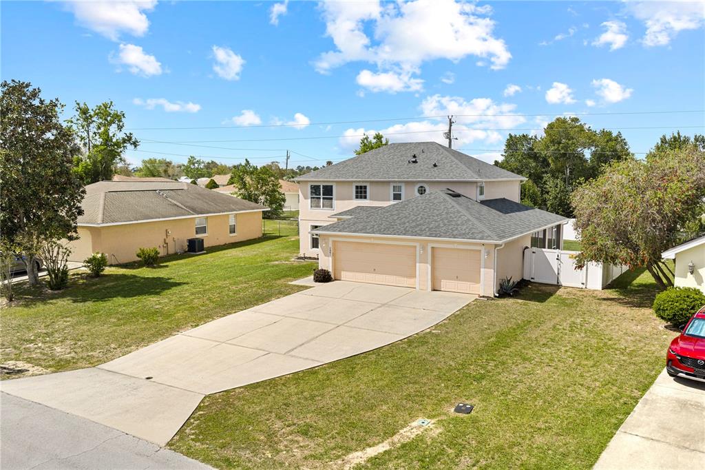 2881 Southwest 142nd Lane Ocala, FL 34473 - Photo 6 of 60 a front view of a house with a yard