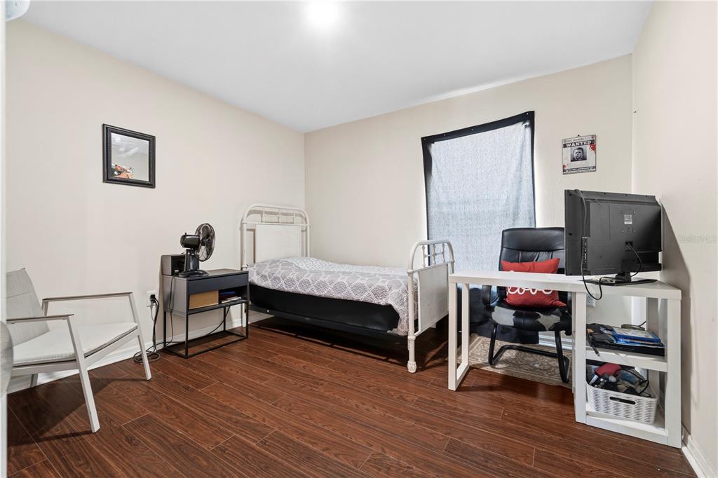 2881 Southwest 142nd Lane Ocala, FL 34473 - Photo 8 of 60 a bedroom with furniture and wooden floor