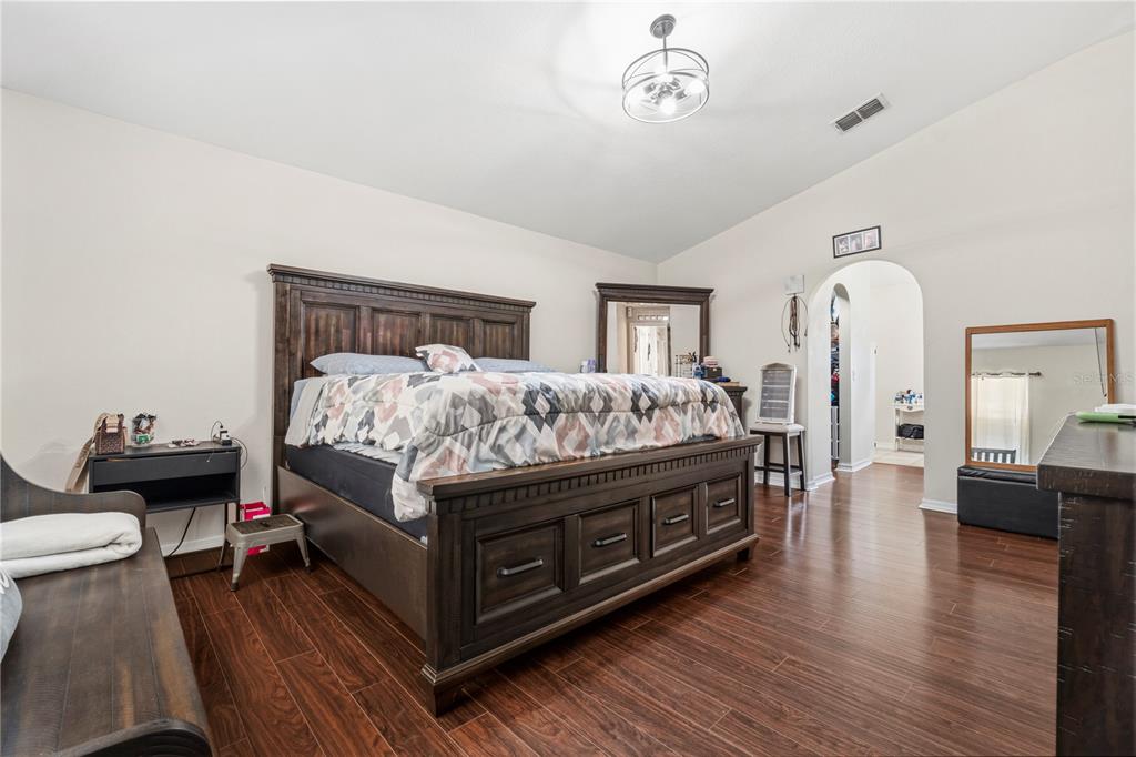 2881 Southwest 142nd Lane Ocala, FL 34473 - Photo 10 of 60 a spacious bedroom with a bed and wooden floor