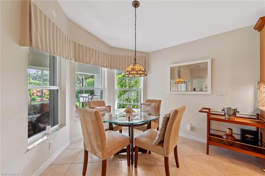 19740 Villa Rosa Loop Estero, FL 33967 - Photo 19 of 42 a dining room with furniture a window and a chandelier