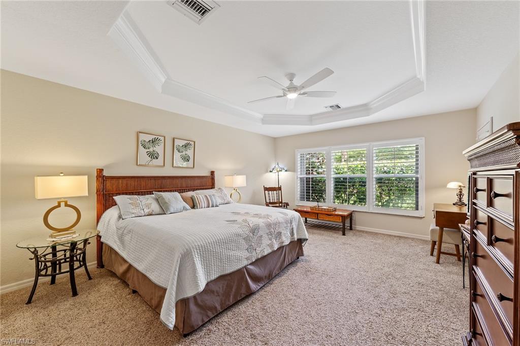 19740 Villa Rosa Loop Estero, FL 33967 - Photo 22 of 42 a spacious bedroom with a bed a table and a large window