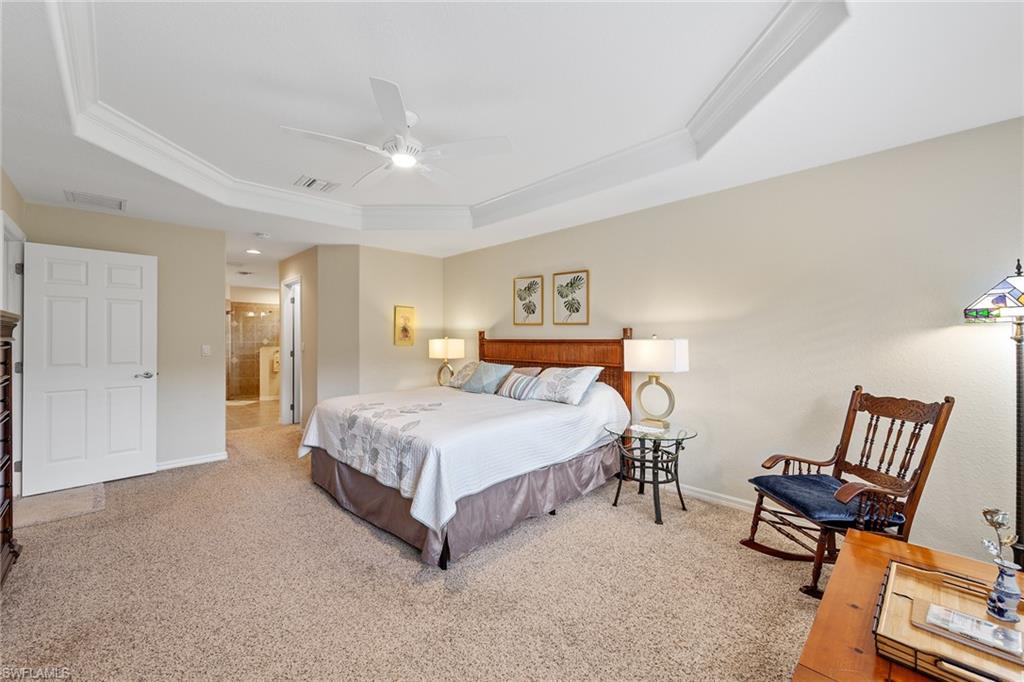 19740 Villa Rosa Loop Estero, FL 33967 - Photo 23 of 42 a spacious bedroom with a bed and a chair