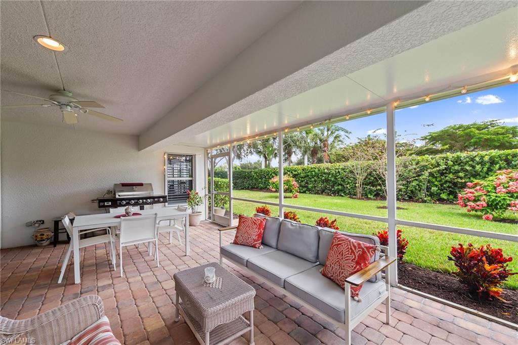 19740 Villa Rosa Loop Estero, FL 33967 - Photo 27 of 42 a living room with patio furniture and a garden