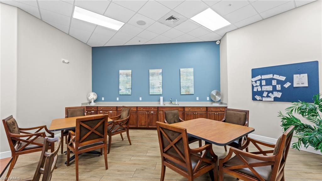 19740 Villa Rosa Loop Estero, FL 33967 - Photo 34 of 42 a dining room with a wooden table and chairs