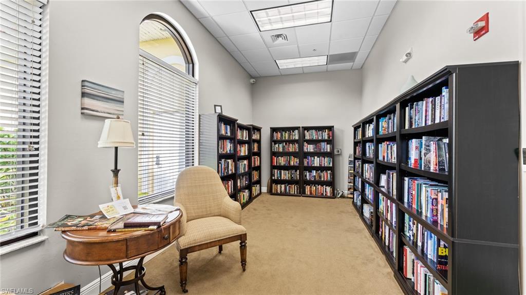 19740 Villa Rosa Loop Estero, FL 33967 - Photo 35 of 42 a living room with furniture and a book shelf