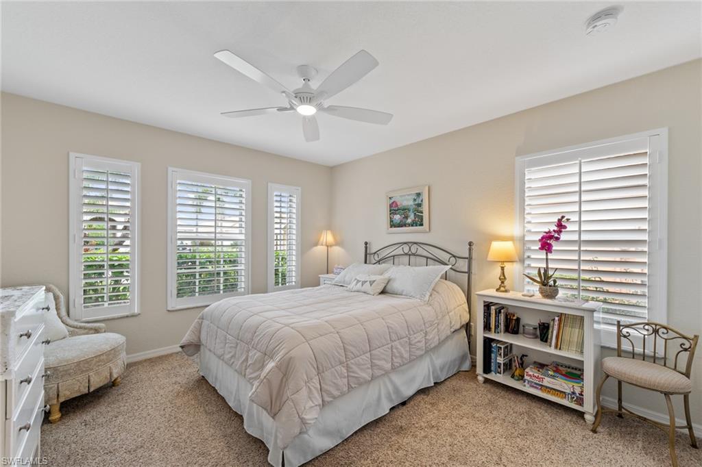 19740 Villa Rosa Loop Estero, FL 33967 - Photo 5 of 42 a bedroom with a bed and a chandelier