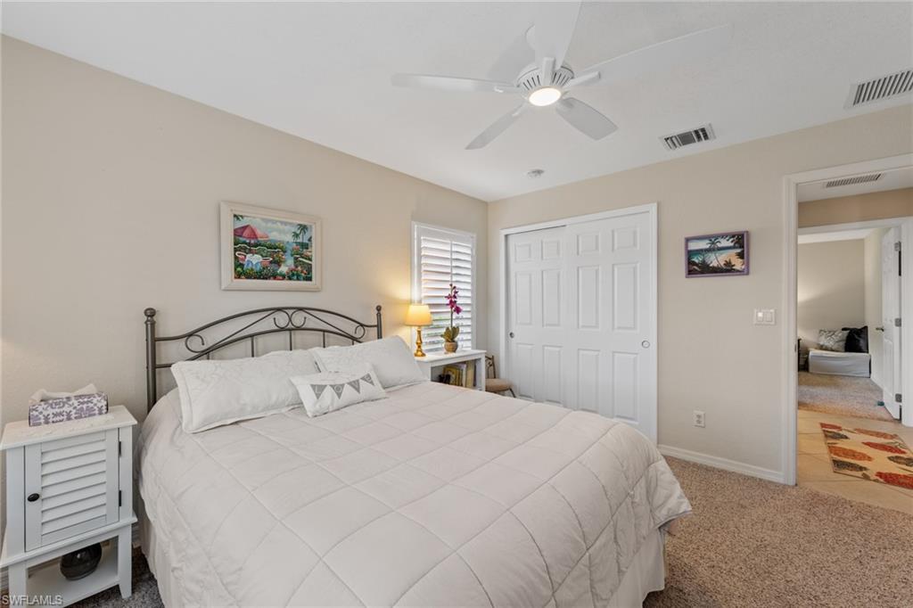 19740 Villa Rosa Loop Estero, FL 33967 - Photo 6 of 42 a bedroom with a large bed and a chandelier