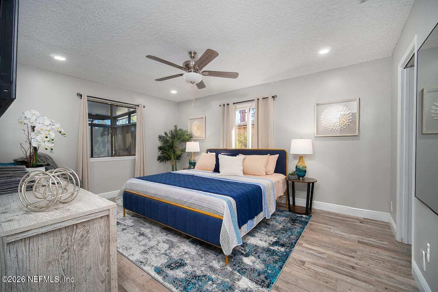 11613 Lake Ride Drive Jacksonville, FL 32223 - Photo 26 of 42 a bedroom with a bed and wooden floor