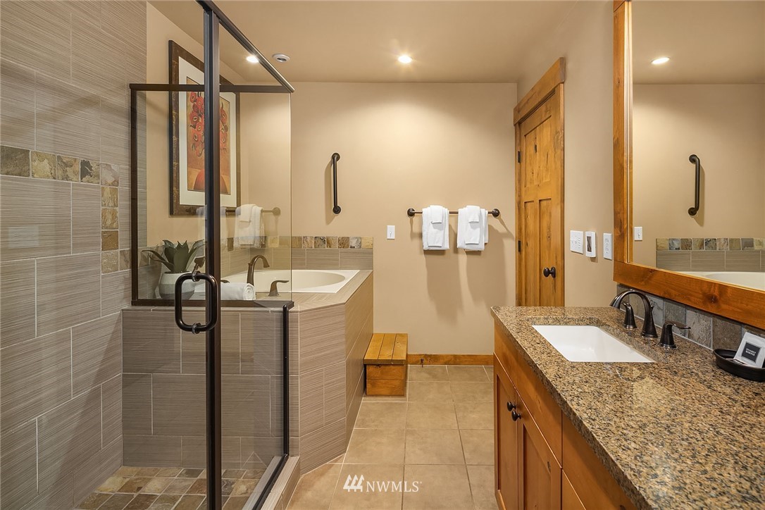 3770 Suncadia Trail, Unit 110 Cle Elum, WA 98922 - Photo 13 of 21 a bathroom with a granite countertop sink a mirror and shower