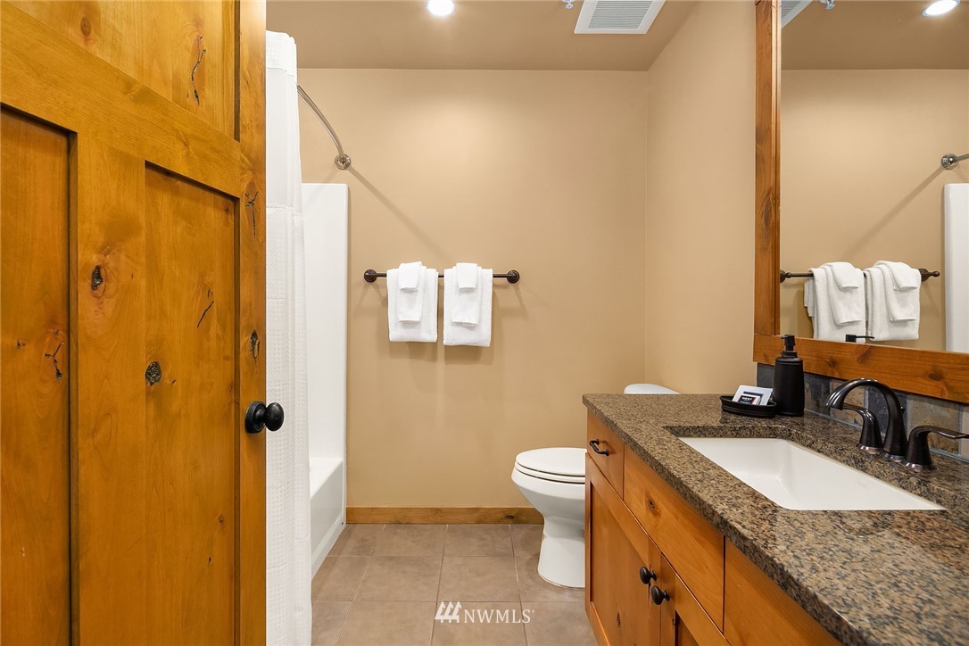 3770 Suncadia Trail, Unit 110 Cle Elum, WA 98922 - Photo 16 of 21 a bathroom with a granite countertop sink toilet and shower