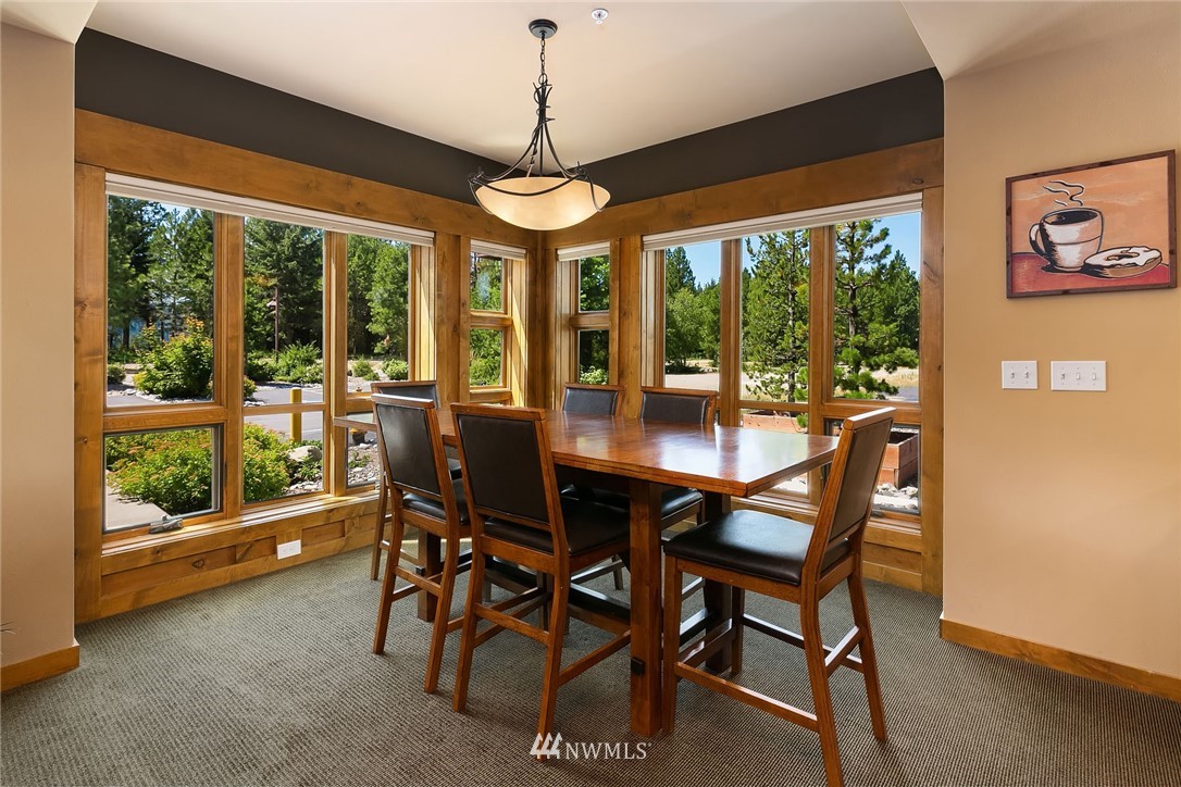 3770 Suncadia Trail, Unit 110 Cle Elum, WA 98922 - Photo 10 of 21 a view of a dining room with furniture large windows and wooden floor