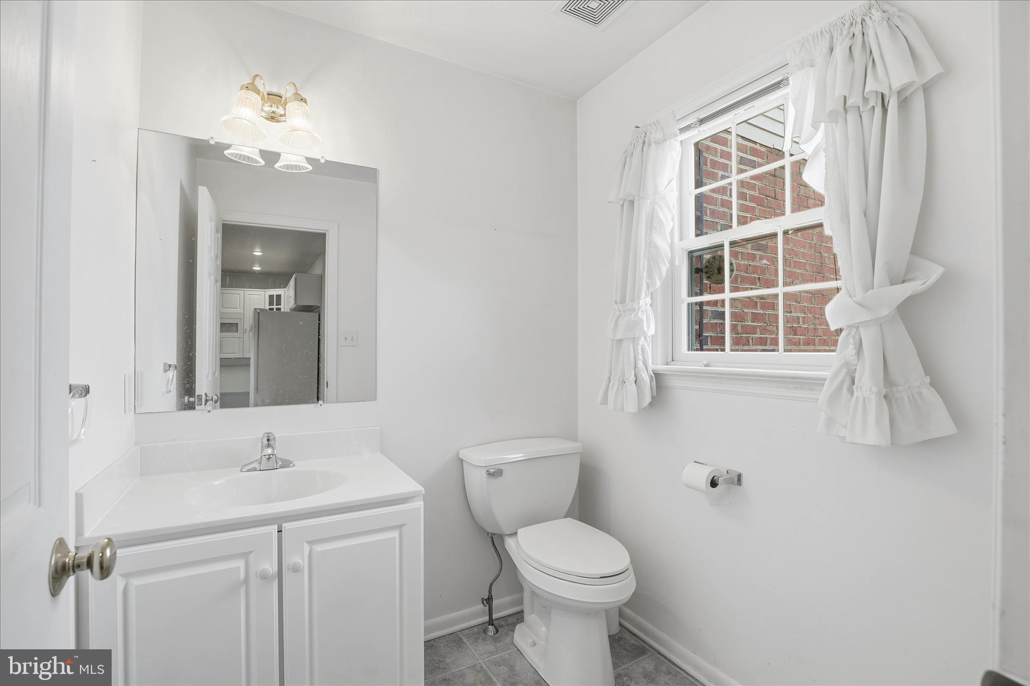 6 Spring Hill Lane Mountville, PA 17554 - Photo 15 of 39 a bathroom with a toilet a sink a window and mirror