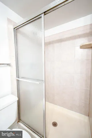 a bathroom with a glass shower door