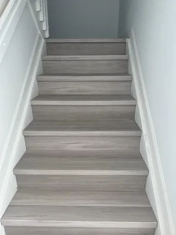 a view of staircase with white walls