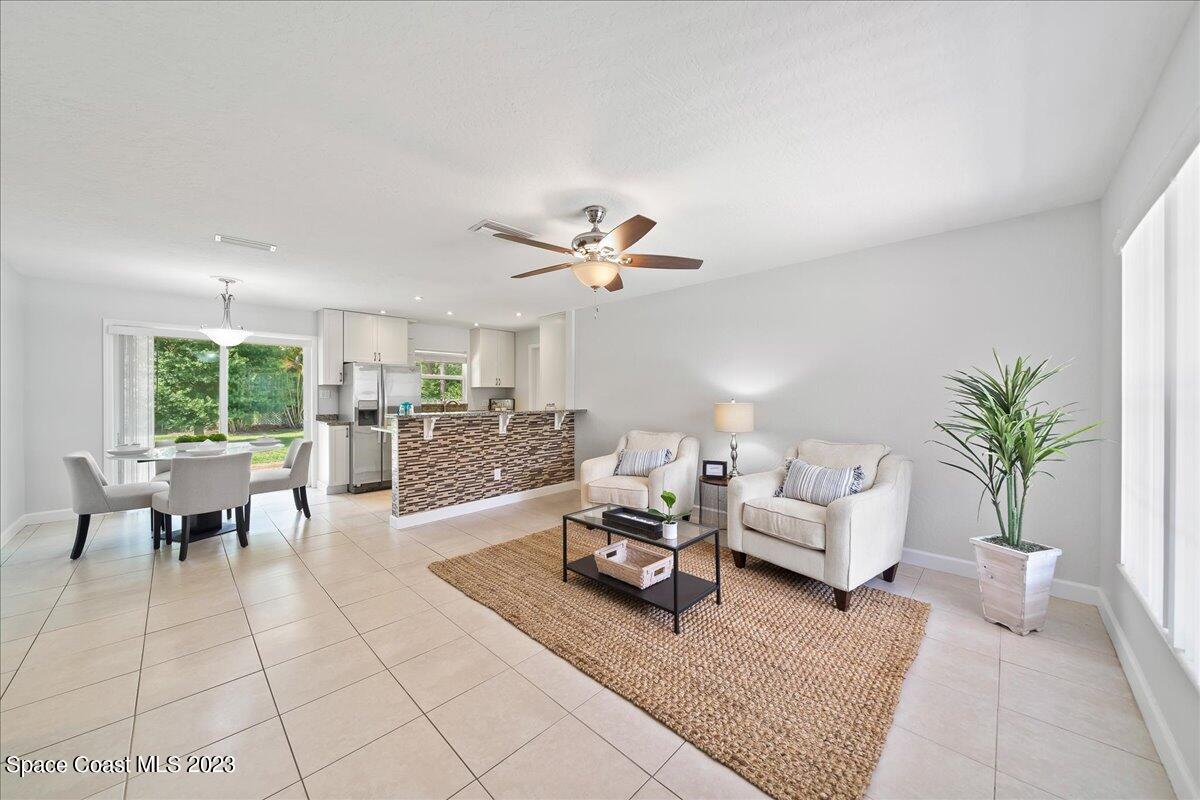 1040 Bernice Road Rockledge, FL 32955 - Photo 6 of 24 a living room with furniture and a large window
