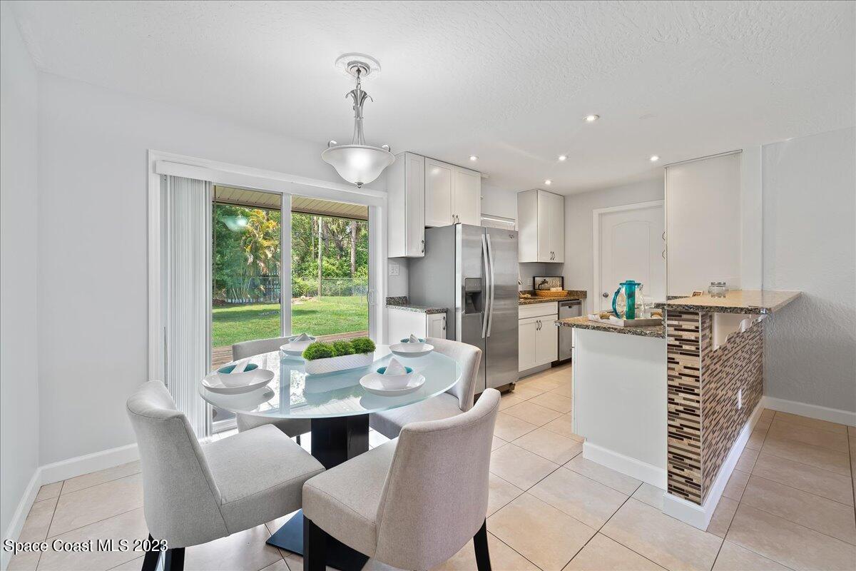 1040 Bernice Road Rockledge, FL 32955 - Photo 7 of 24 a view of a dining room with furniture window and outside view