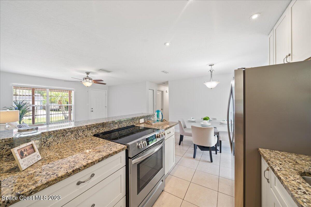1040 Bernice Road Rockledge, FL 32955 - Photo 10 of 24 a kitchen with a stove and a refrigerator