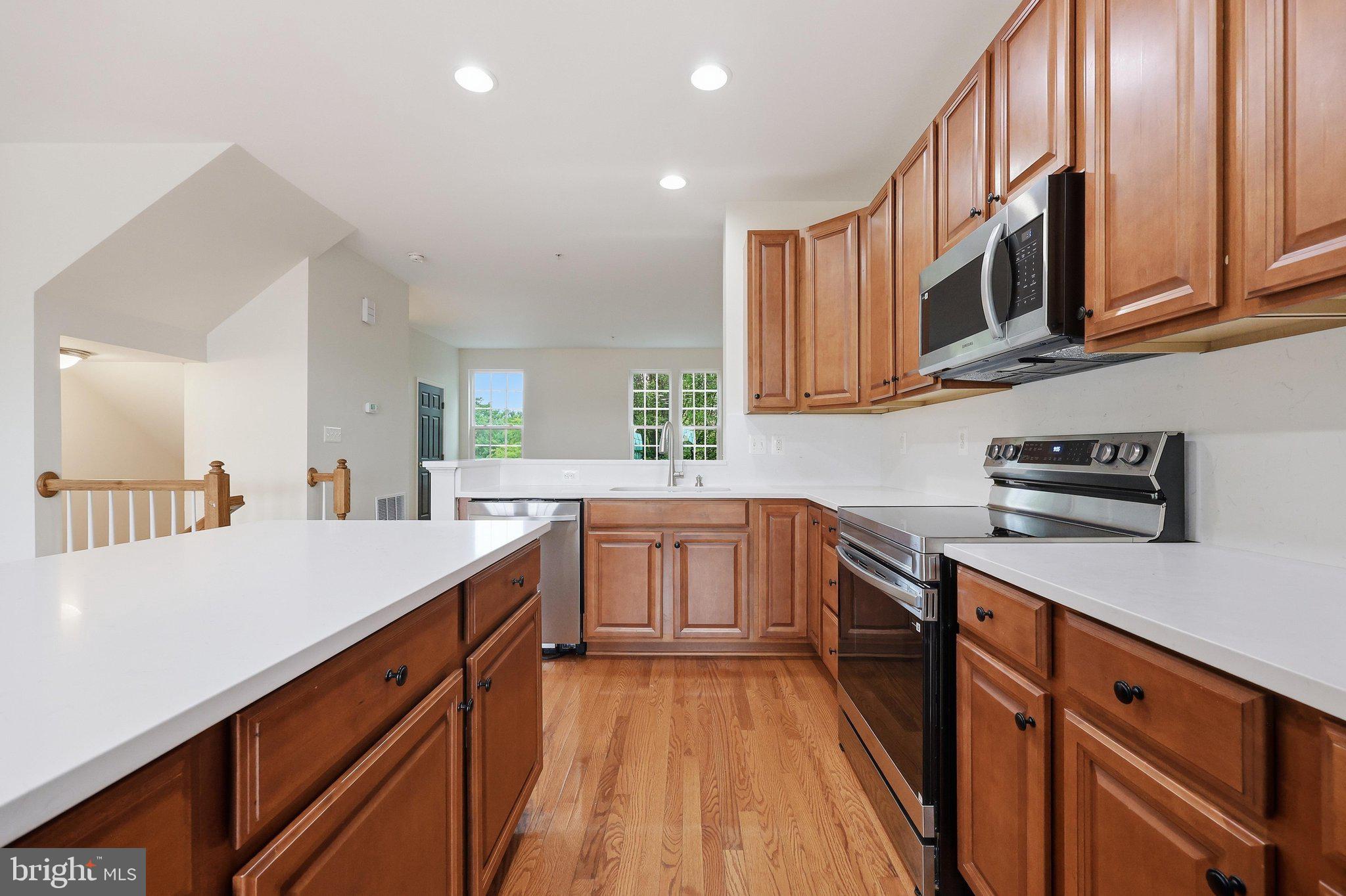 2075 Spring Run Circle Frederick, MD 21702 - Photo 18 of 59 a kitchen with stainless steel appliances granite countertop a stove and a sink