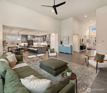a living room with furniture and kitchen view