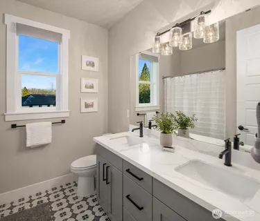 a bathroom with a sink a toilet and mirror