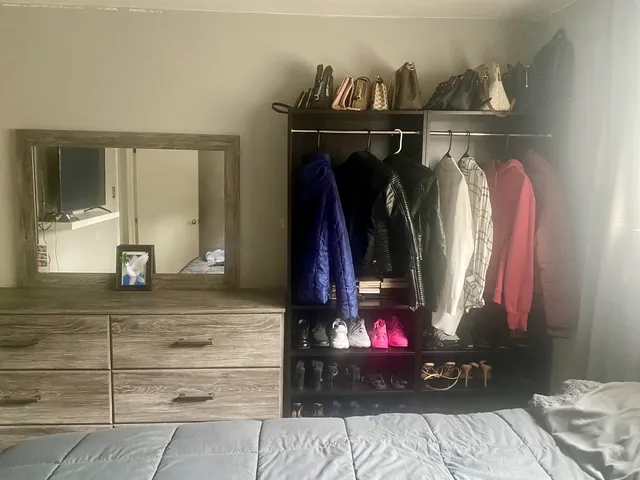 a view of a room with wooden floor and window