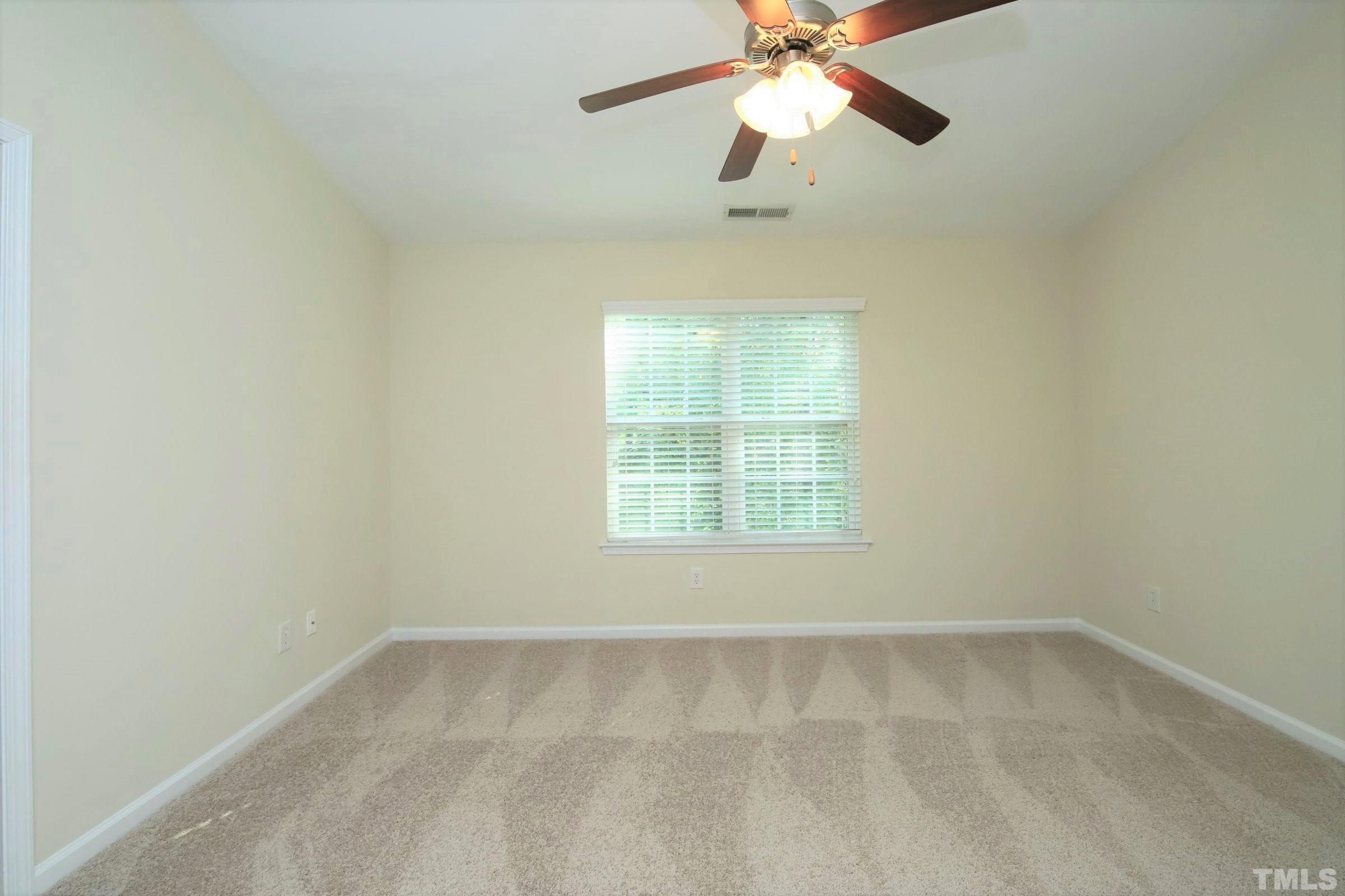 3118 Binghampton Lane Raleigh, NC 27604 - Photo 15 of 27 an empty room with a window and a fan