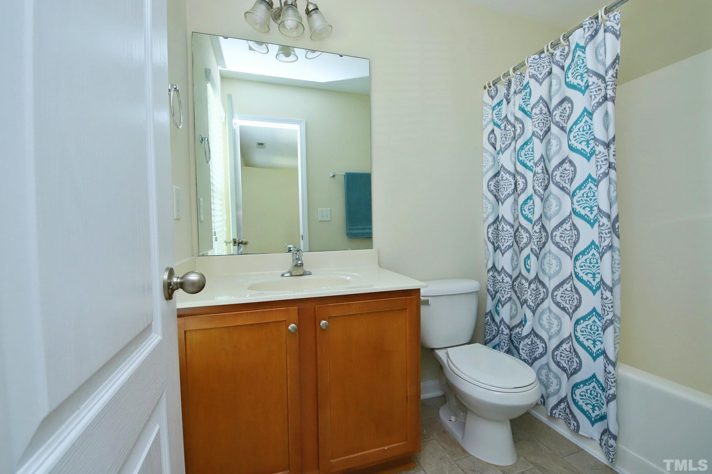 3118 Binghampton Lane Raleigh, NC 27604 - Photo 21 of 27 a bathroom with a toilet sink and mirror