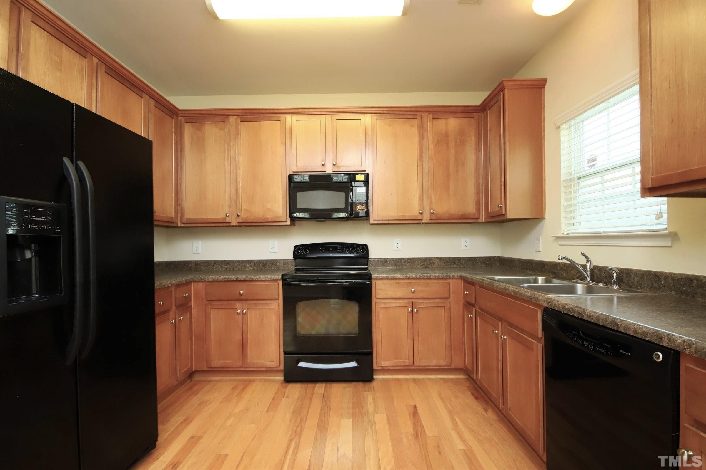 3118 Binghampton Lane Raleigh, NC 27604 - Photo 8 of 27 a kitchen with stainless steel appliances granite countertop a stove a sink and a refrigerator