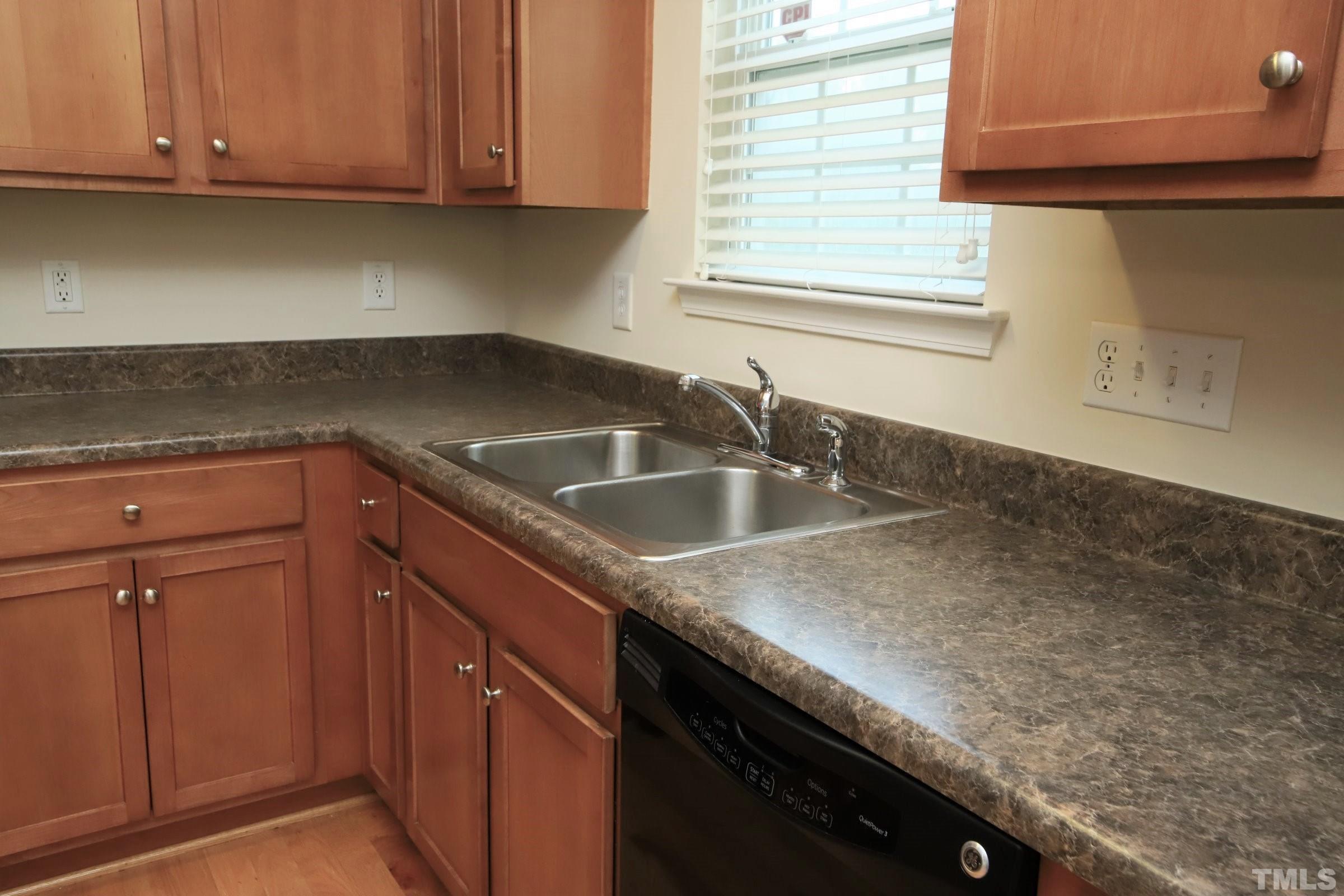 3118 Binghampton Lane Raleigh, NC 27604 - Photo 10 of 27 a kitchen with granite countertop a sink dishwasher and cabinets with wooden floor