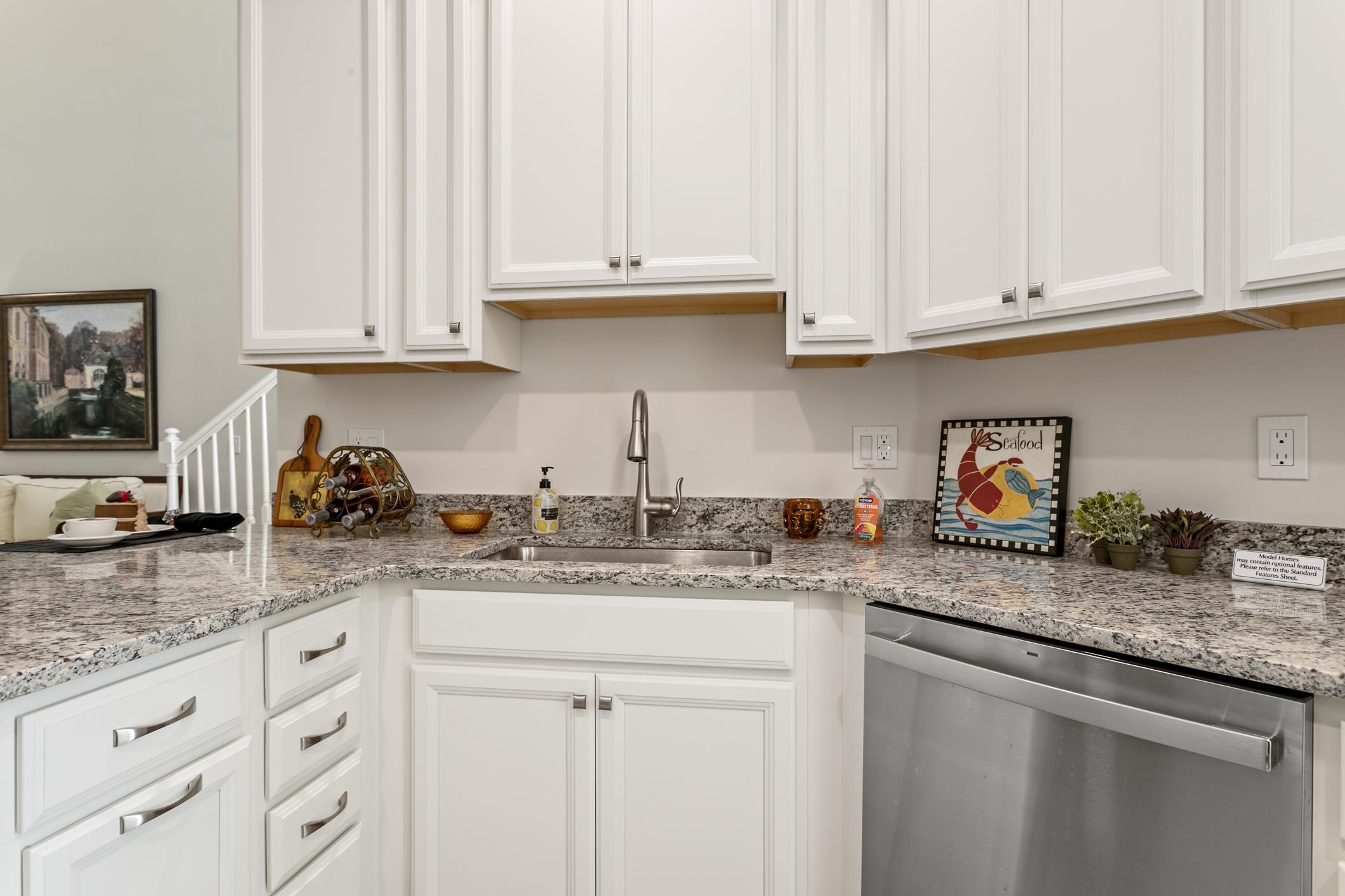 264 Grand Ravine Drive St. Augustine, FL 32086 - Photo 12 of 46 a kitchen with granite countertop white cabinets and white appliances