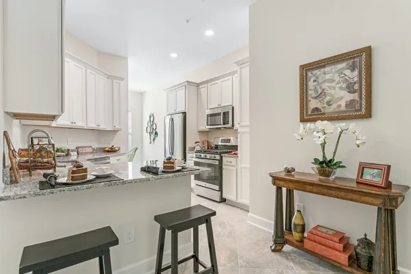 a view of kitchen with furniture and refrigerator