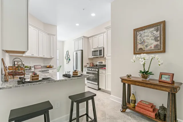 a view of kitchen with furniture and refrigerator