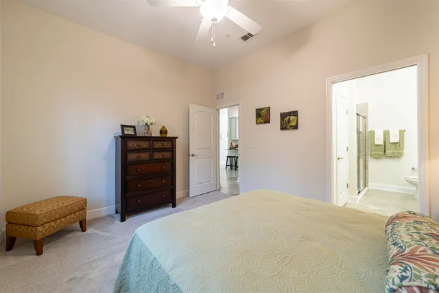 a bathroom with a granite countertop sink and shower