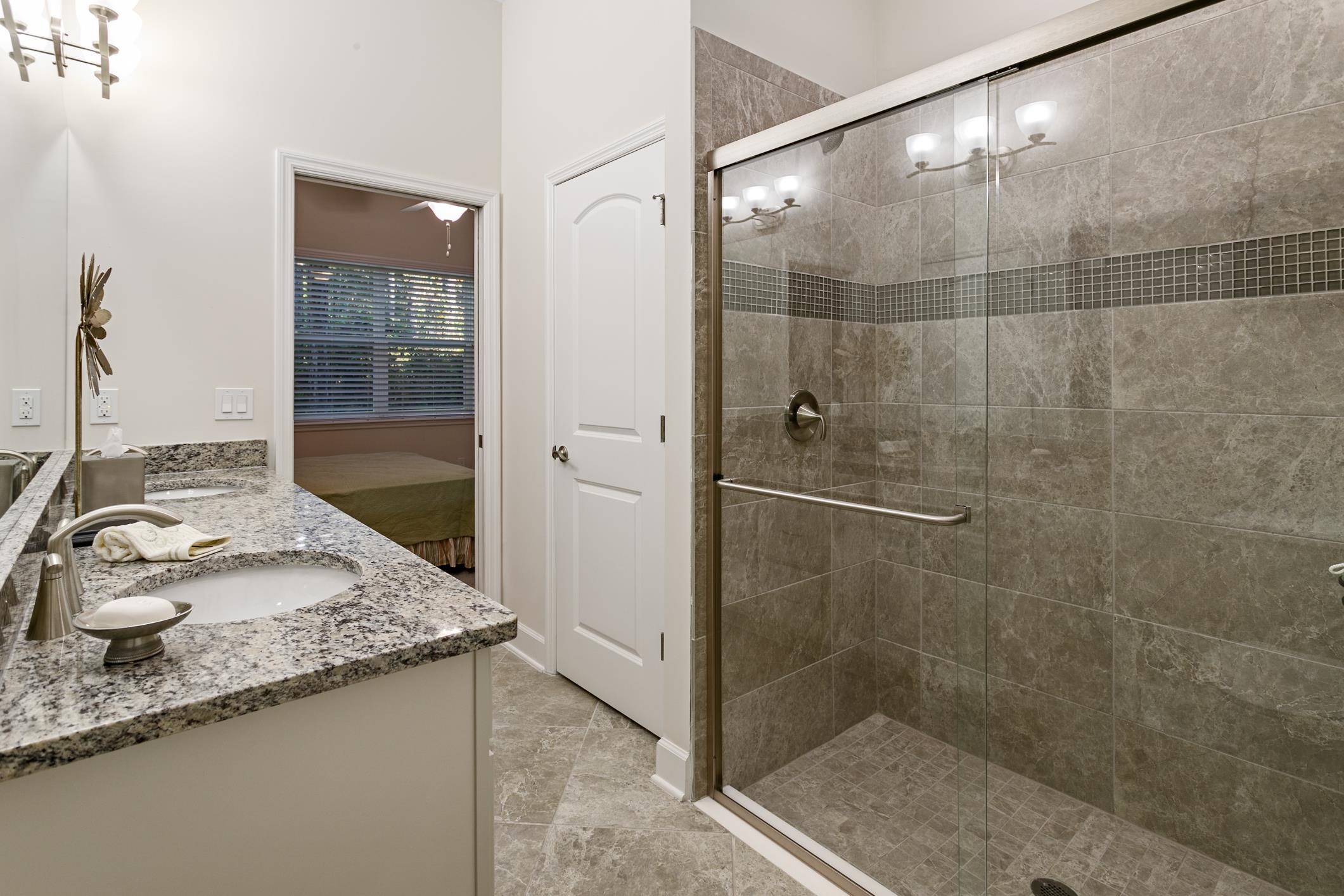 264 Grand Ravine Drive St. Augustine, FL 32086 - Photo 22 of 46 a bathroom with a granite countertop sink and shower