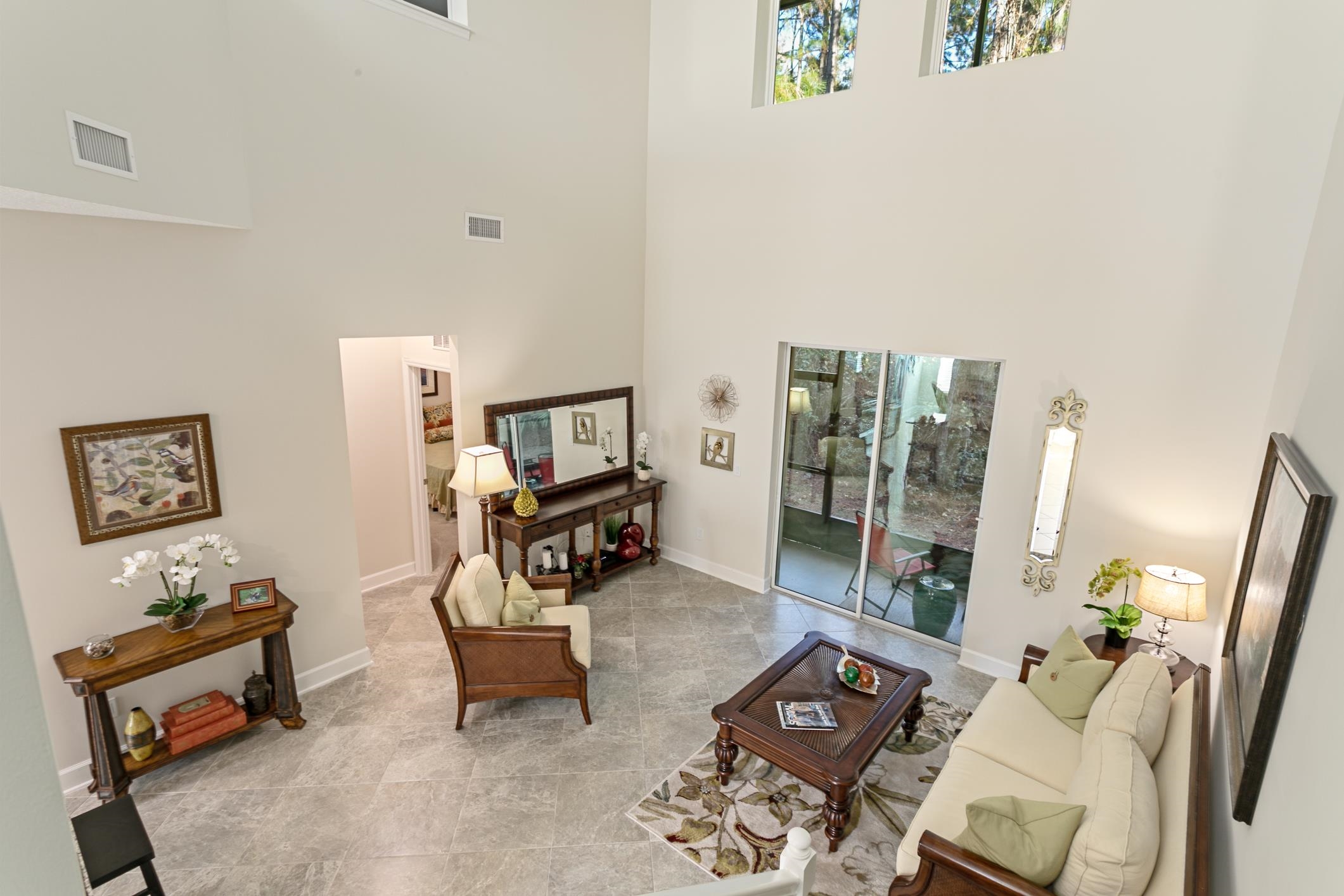 264 Grand Ravine Drive St. Augustine, FL 32086 - Photo 29 of 46 a living room with furniture a rug and a flat screen tv