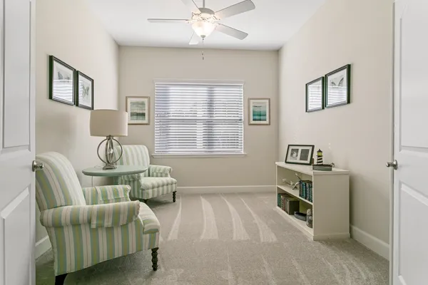 a living room with furniture and a lamp