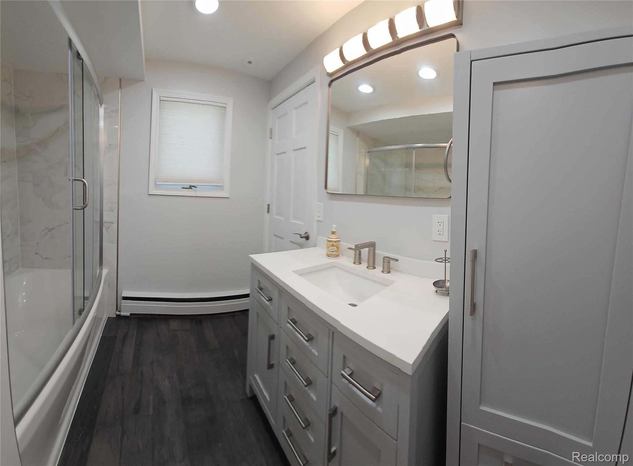 10202 Buhl Road Pinckney, MI 48169 - Photo 13 of 19 Contemporary bathroom featuring a light gray vanity with a white countertop and undermount sink
