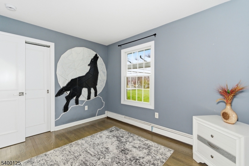 18 Old Wolfe Road Budd Lake, NJ 07828 - Photo 21 of 49 a view of a bedroom with wooden floor and a window