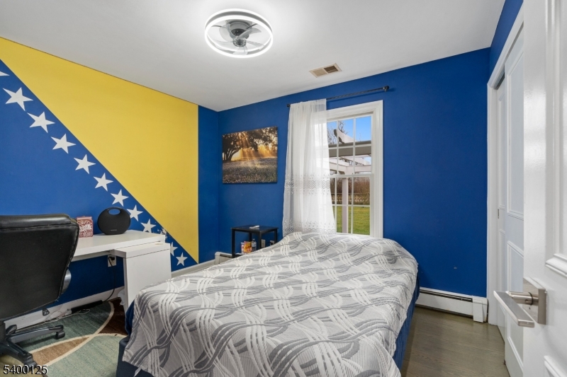 18 Old Wolfe Road Budd Lake, NJ 07828 - Photo 22 of 49 a bedroom with a bed and a flat tv screen on dresser