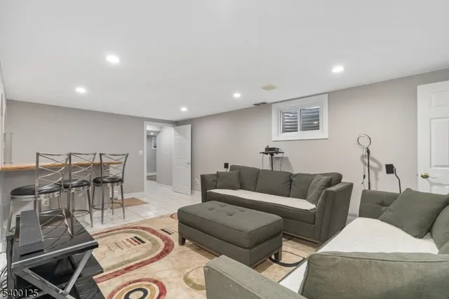 a living room with furniture and a view of kitchen