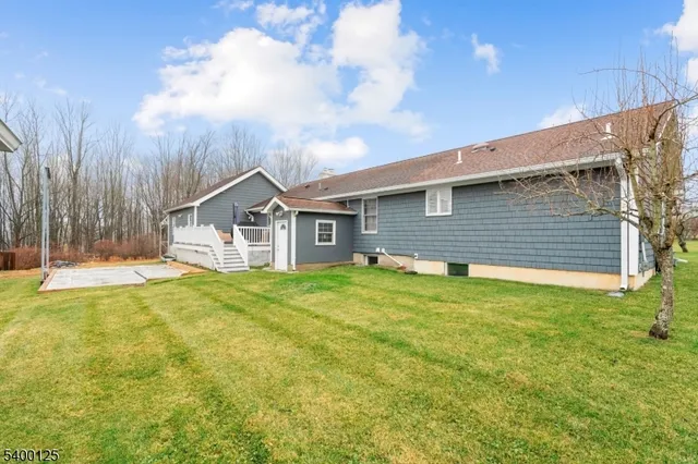 a view of a house with a backyard