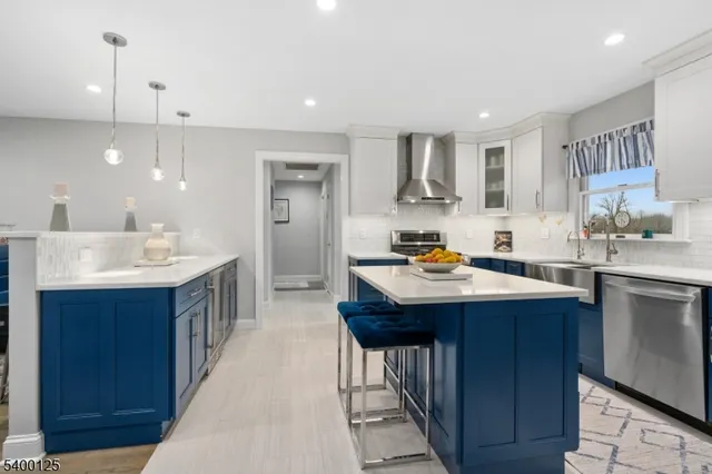 a kitchen with kitchen island a sink appliances and cabinets
