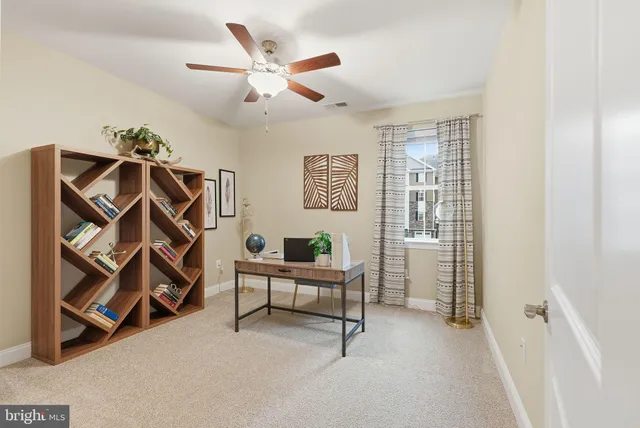 a view of a livingroom with furniture and staircase